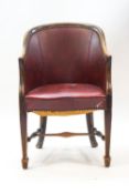 A 19th century framed tub shaped chair with leatherette seat and back