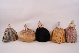 Five 19th century and 20th century porcelain pin cushion half dolls with full skirts,
