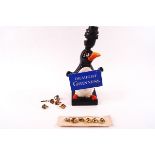 A Guinness advertising pottery table lamp, modelled as a penguin holding a 'Draught Guinness' sign,