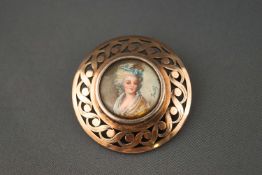 A sterling silver brooch set with a miniature hand painted portrait. Pin and sleeve fitting. 12.