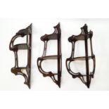 A set of three reproduction mahogany three tier hanging shelves,