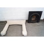 A carved sandstone mantelpiece/fire surround with cast iron grate inset,