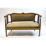 An Edwardian inlaid mahogany salon suite, comprising a two seat sofa,