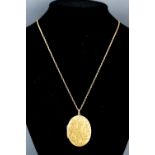 A hallmarked 9ct gold oval engraved locket on rope chain. 17.