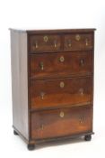 An 18th century style walnut chest of five drawers on bun feet,
