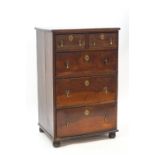 An 18th century style walnut chest of five drawers on bun feet,