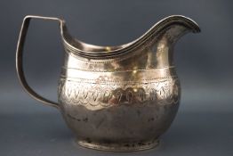 A George III silver cream jug, with reeded handle and bright cut decoration, London 1809,
