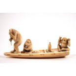 An early 20th century Japanese ivory carving of three monkeys in a boat,