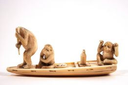 An early 20th century Japanese ivory carving of three monkeys in a boat,