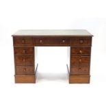 A reproduction walnut pedestal desk,