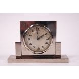 An Art Deco chrome bedside clock, monogrammed FGM,