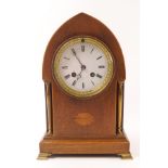 An Edwardian mahogany mantel clock of lancet shape, the eight day movement striking on a bell,