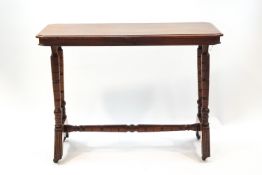 A Victorian mahogany stretcher table with canted corners on turned supports,