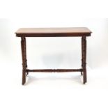 A Victorian mahogany stretcher table with canted corners on turned supports,