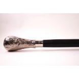An ebonised heavy walking cane with white metal knop