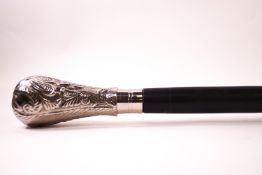 An ebonised heavy walking cane with white metal knop