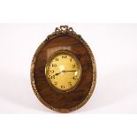 A French gilt metal and tortoiseshell oval bedside clock,