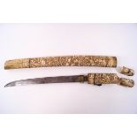 An early 20th century Japanese knife within an ivory sheath,