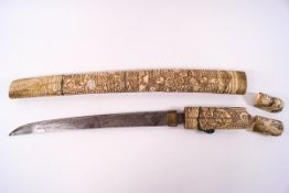An early 20th century Japanese knife within an ivory sheath,