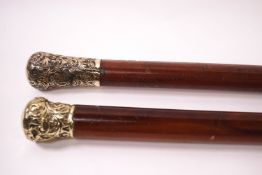 A pair of malacca walking canes with decorative knops