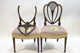 A pair of George III mahogany side chairs, heart shape backs with pierced fan splats,