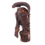 An African carved hardwood bust of a bearded tribal man, signed T Musole to the neck,