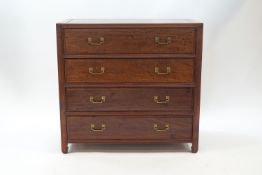 A 20th century Chinese hardwood chest of four drawers with brass handles,