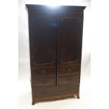 A 19th century mahogany double wardrobe with faux drawer door and drawer to base on splay feet,