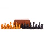 A turned ebonised and natural wood chess set,