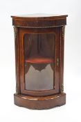 A Victorian walnut and crossbanded bow front standing corner cabinet with gilt metal mounts,