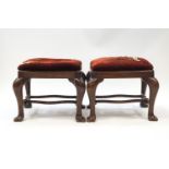 A pair of George II style oak stools on cabriole legs and paw feet,