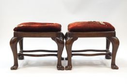 A pair of George II style oak stools on cabriole legs and paw feet,