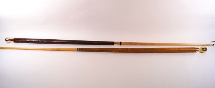 A near pair of carved walking sticks, converting to pool cues,