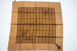 A Burberry silk scarf with original card sleeve and carrier bag