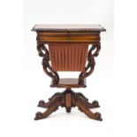 A reproduction mahogany work table with drawer over a slide out wool box, on carved scroll base,