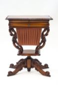 A reproduction mahogany work table with drawer over a slide out wool box, on carved scroll base,