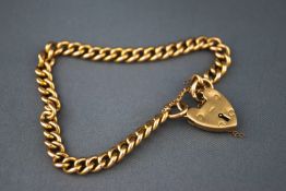A heavy yellow gold curb bracelet, padlock and safety chain. Hallmarked 9ct gold, London, 1957.