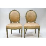 A pair of French style painted salon chairs with oval backs,