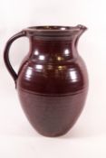 A Studio pottery jug by John Leech with brown concentric circle glaze, impressed JL monogram,