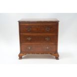 A reproduction walnut batchelor's chest of three drawers with brushing slide,