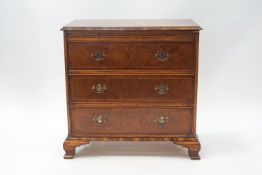 A reproduction walnut batchelor's chest of three drawers with brushing slide,