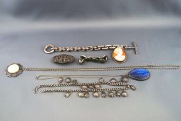 A selection of jewellery to include a silver cameo brooch, a heavy weight bracelet,