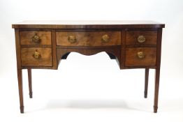 A 19th century mahogany serpentine fronted sideboard with one frieze draw,