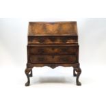 A Queen Anne style walnut bureau of small proportions,