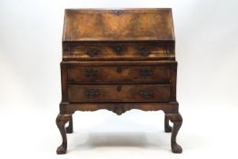 A Queen Anne style walnut bureau of small proportions,