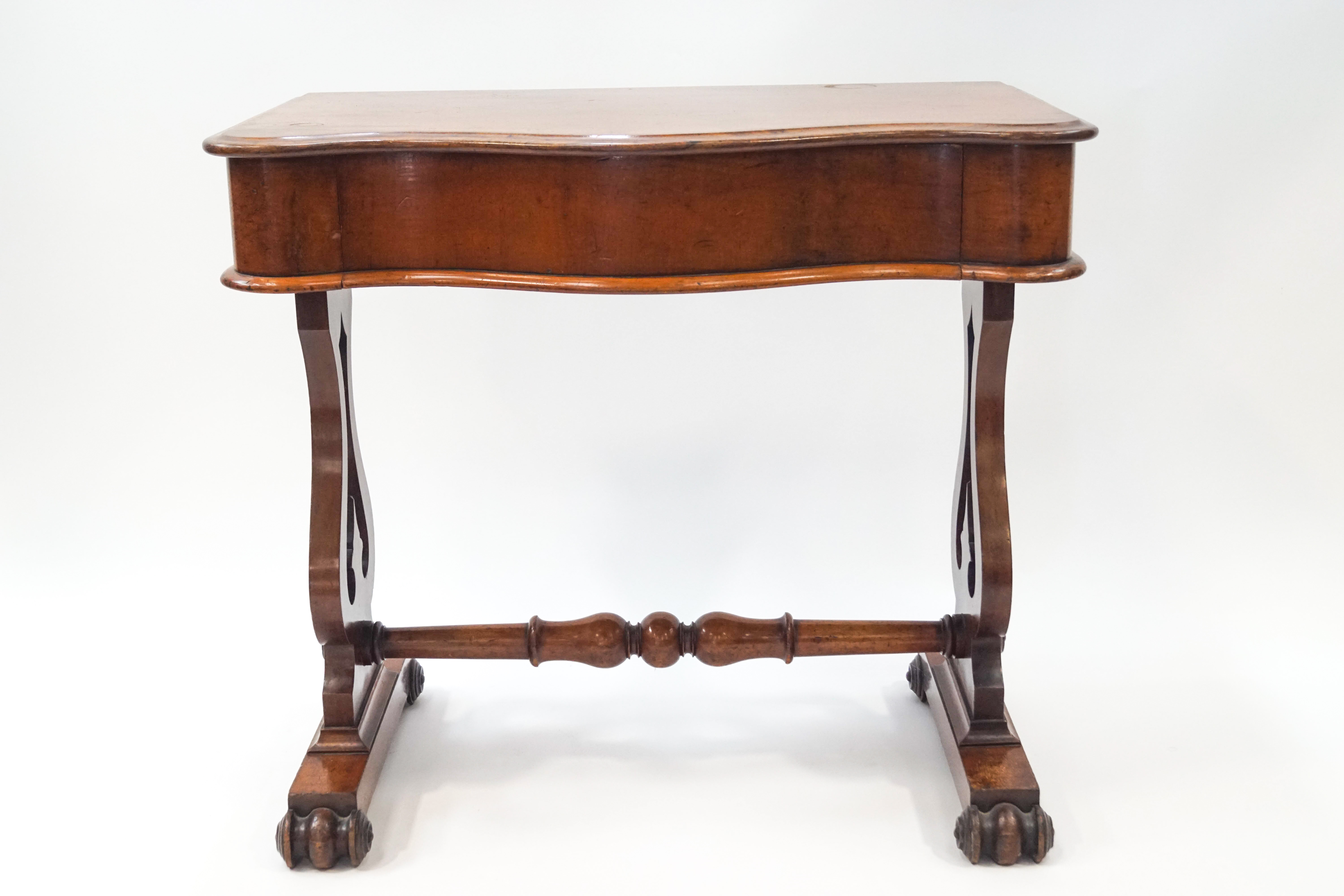 A Victorian mahogany side table with drawer serpentine front on lyre supports joined by a turned