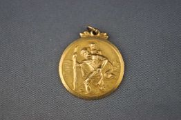 A hallmarked 9ct gold Saint Christopher pendant. 4.