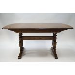 An Ercol elm draw leaf dining table with stretchered base, 74cm high x 152cm wide x 92cm deep,