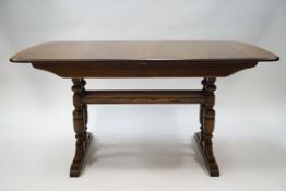 An Ercol elm draw leaf dining table with stretchered base, 74cm high x 152cm wide x 92cm deep,