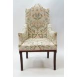 An Edwardian inlaid mahogany armchair with front sabre legs